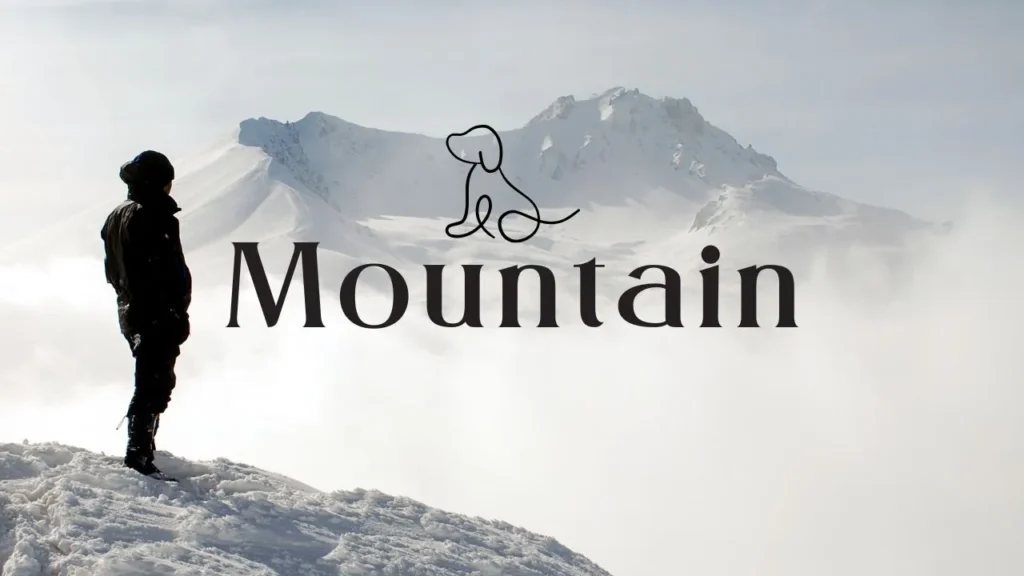 A person stands triumphantly on a mountain peak, with the word "mountain" displayed in bold black and white.